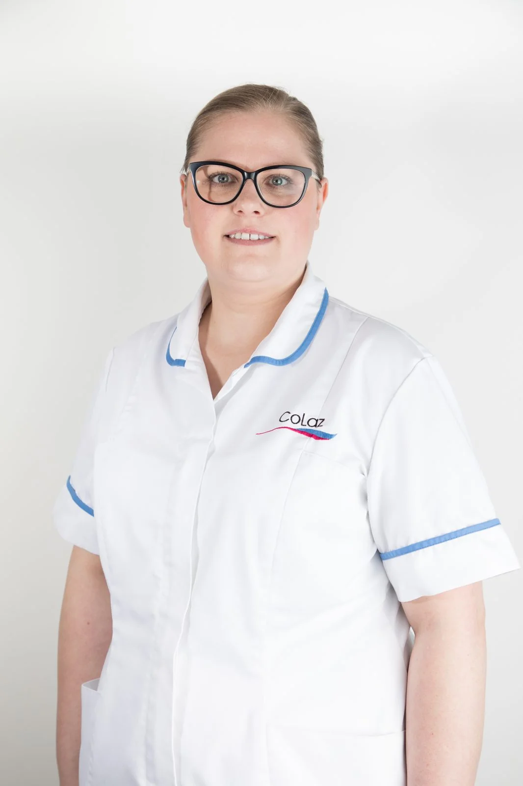 Portrait of a qualified CoLaz Hounslow clinician in branded uniform