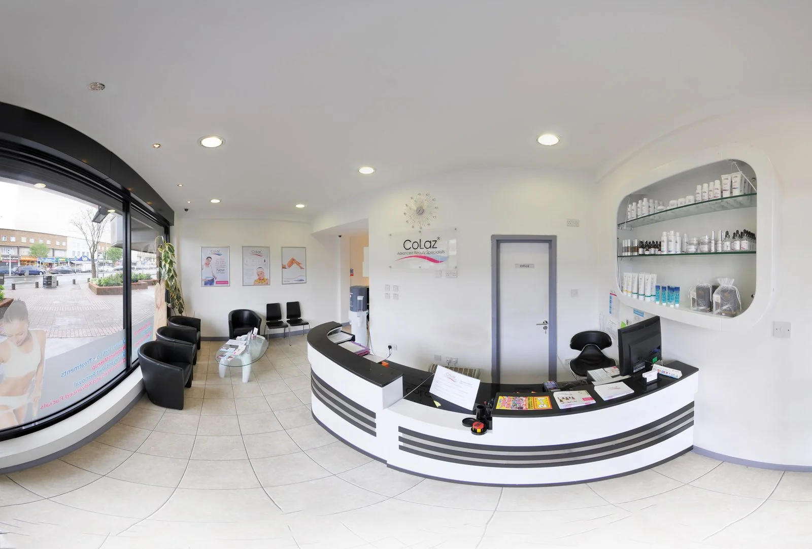 Bright reception and waiting area at the CoLaz Slough clinic on Farnham Road, with the curved white reception desk and a glazed shopfront looking onto the street