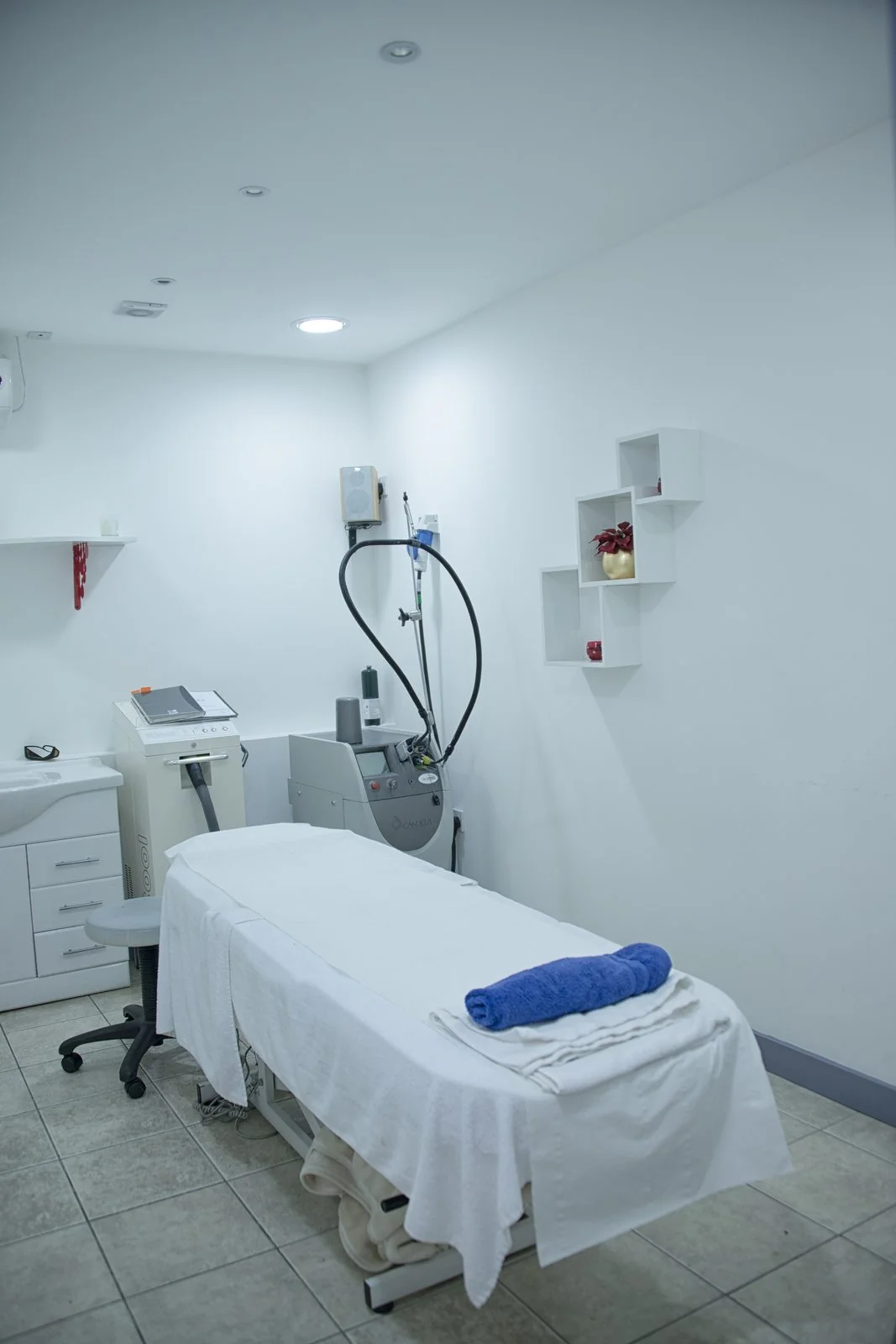 Laser treatment room at the CoLaz Slough clinic with clinical-grade laser equipment beside the bed