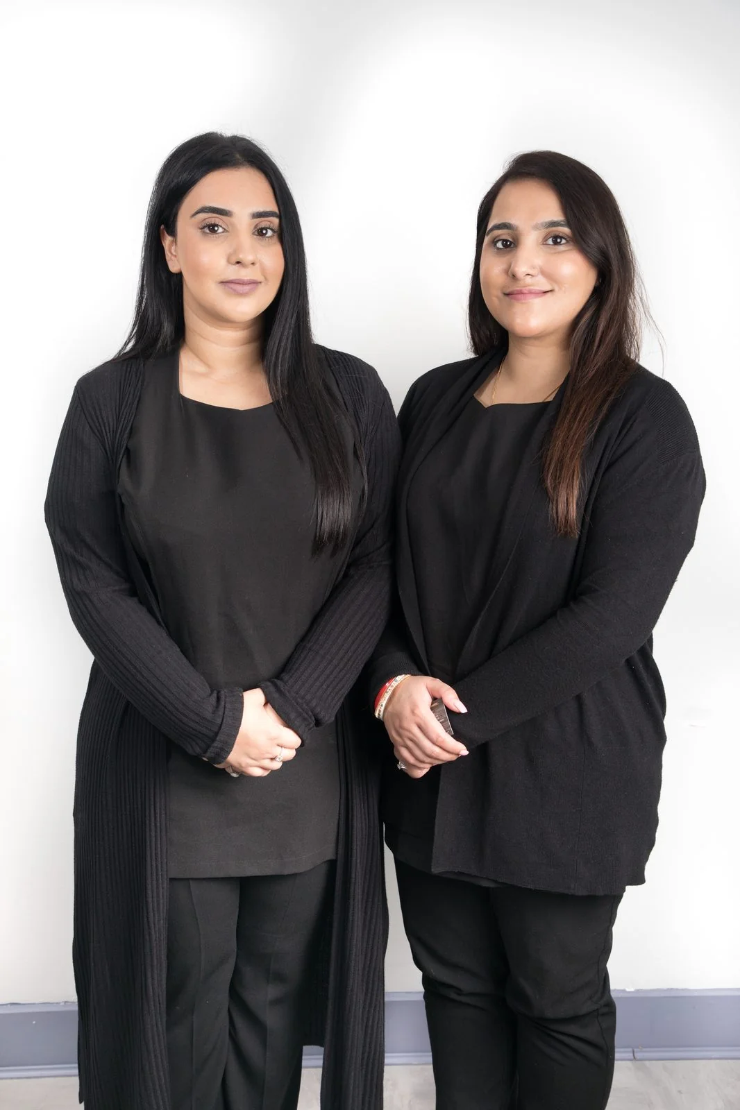 Two qualified clinicians of the CoLaz Southall team in black uniform