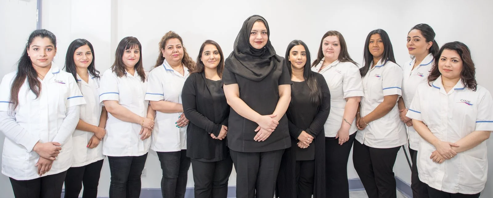 The eleven-strong CoLaz Southall team in branded uniform with the lead clinician in the centre