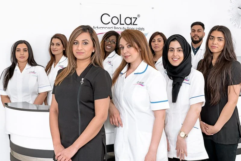 The CoLaz team of qualified clinicians in branded uniform at the clinic reception