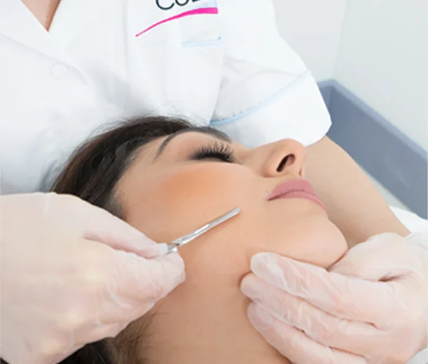 CoLaz therapist performing a dermaplaning treatment on a calm patient