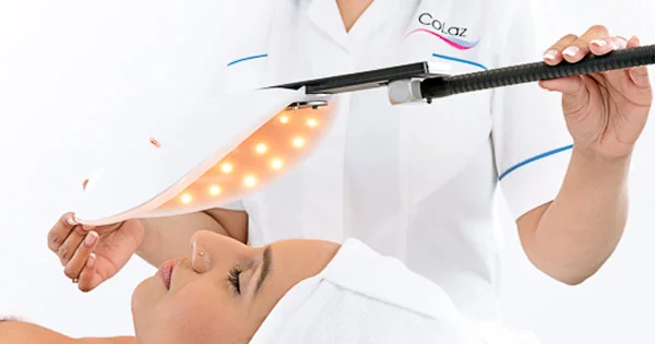 CoLaz patient relaxing under an LED light therapy panel