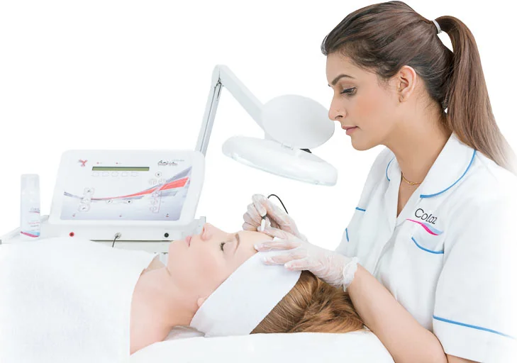 CoLaz clinician working under a magnifying lamp to assess the delicate eye area before precision milia removal
