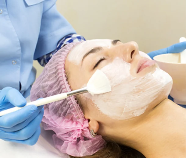 CoLaz clinician brushing a calming hydration mask over a patient's face