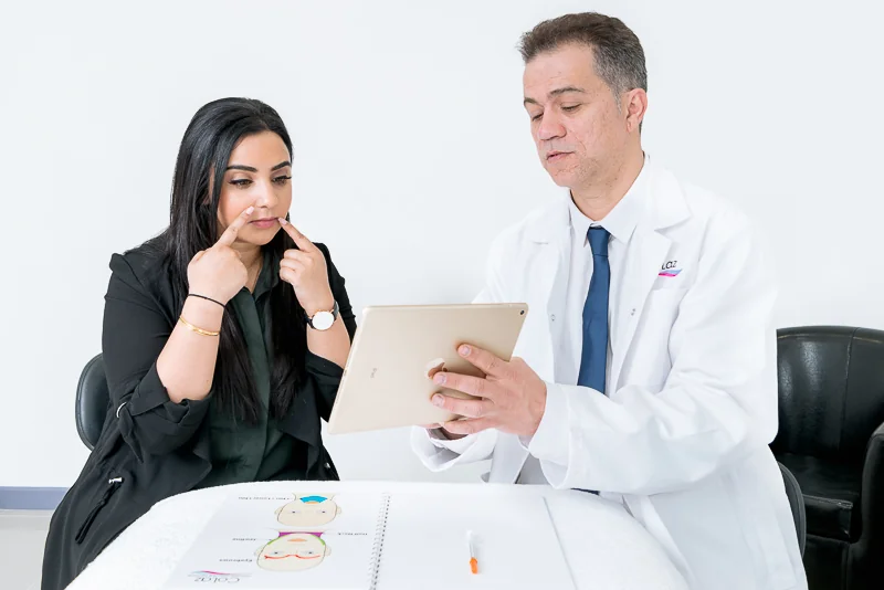 CoLaz doctor reviewing a Sunekos consultation chart with a patient
