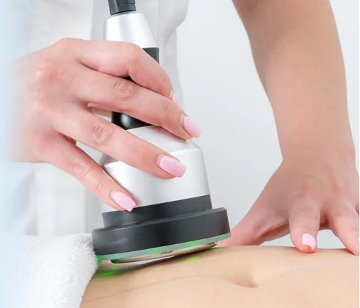 Close-up of a CoLaz clinician guiding the ultrasound cavitation handpiece across a patient's lower abdomen